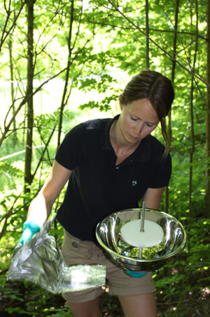 Scientist Helene Lunder Halvorsen is putting together a “PUF-PAS” passive air sampler, which due to its shape is commonly called a UFO. The white disc in the middle is a foam filter, which captures various environmental contaminants during the three-month deployment. 